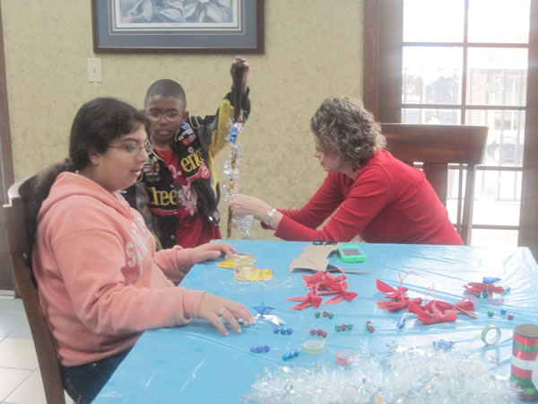 Braylon and Laura decorate his cane for the holidays